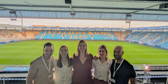 Group picture in fron of the stadium: asp 2025