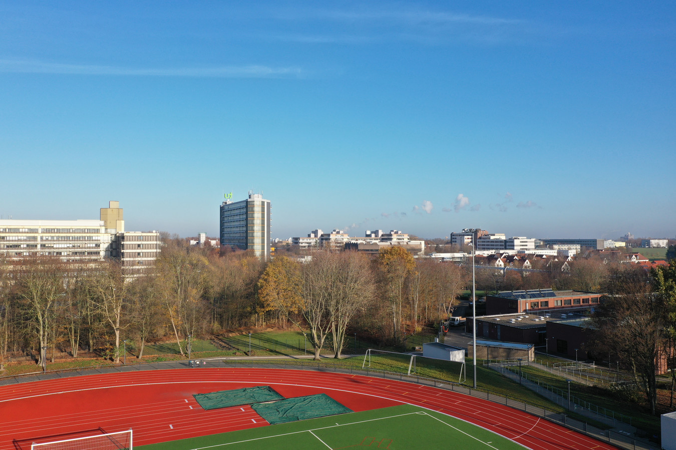 Blick aus großer Höhe über den Sportplatz des IfSS bis zum Sportinstitut und den Mathetower.